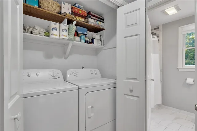 a view of storage and utility room with washer and dryer
