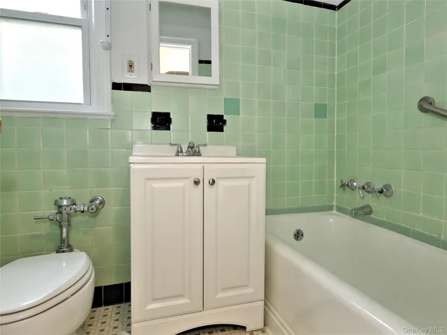 a view of a hallway with wooden floor and closet