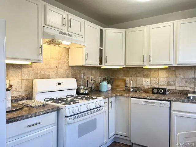 a kitchen with a stove and a refrigerator