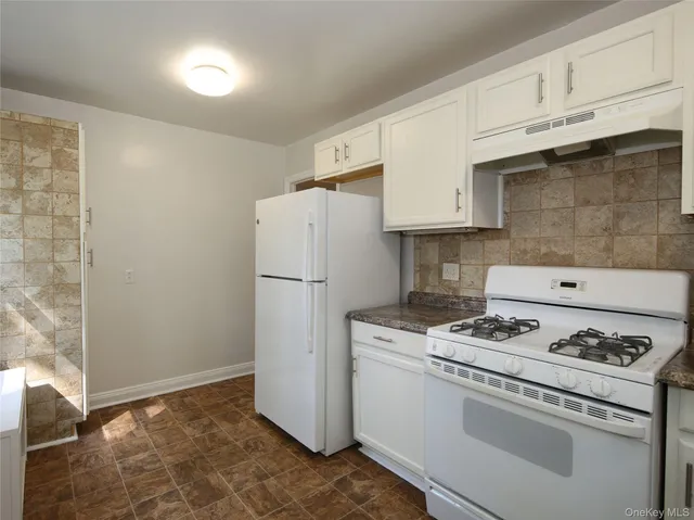 a kitchen with a table and chairs in it