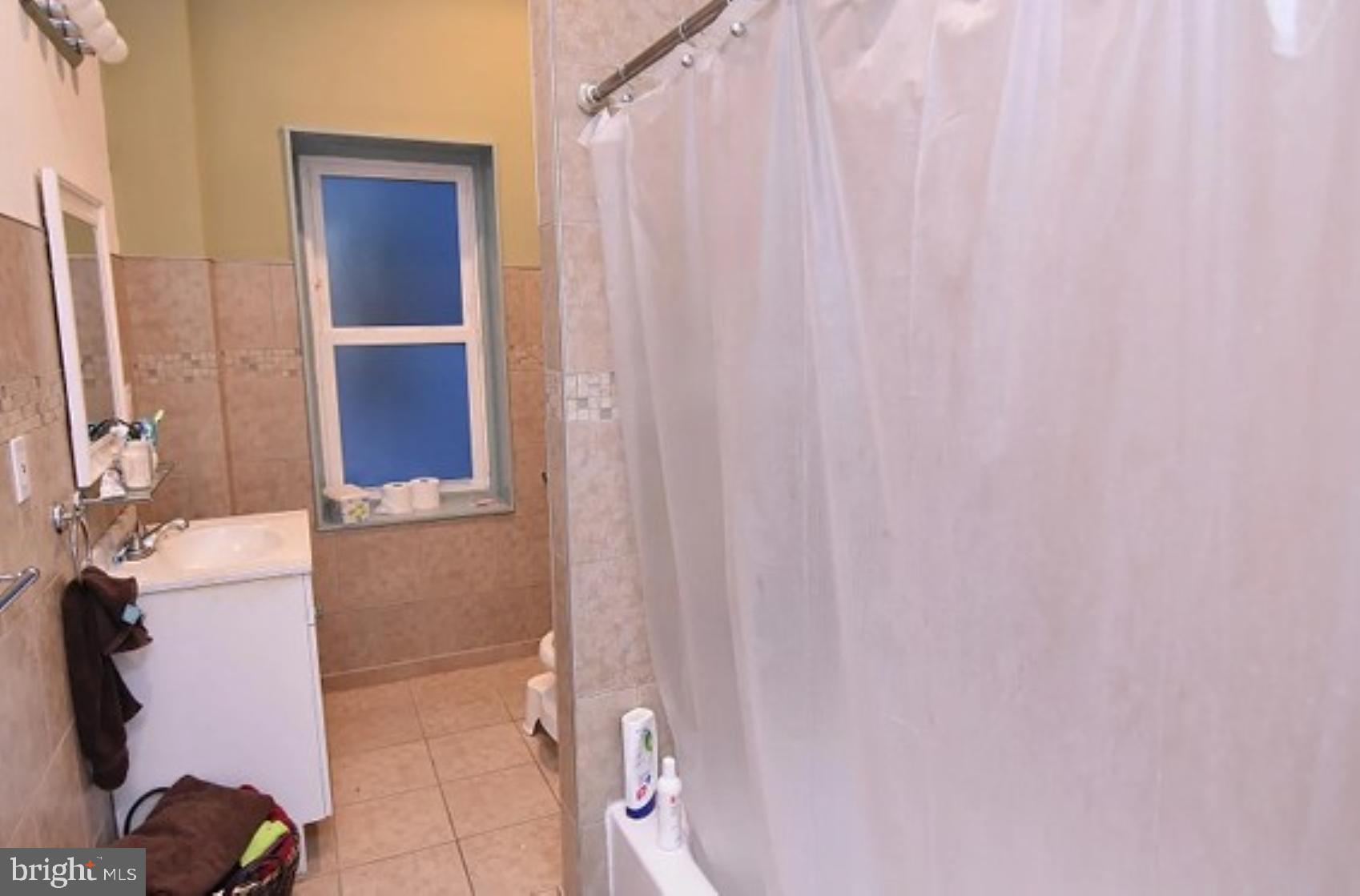 118 South 46th Street Philadelphia, PA 19139 - Photo 4 of 7 a bathroom with a bathtub and shower