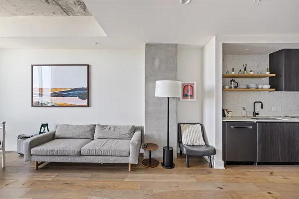 a living room with furniture and a lamp