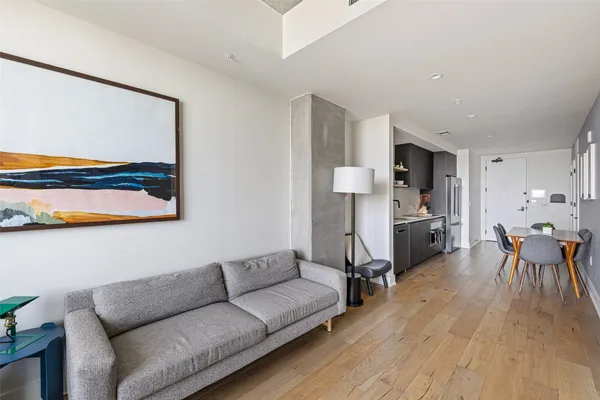 a living room with furniture and kitchen view