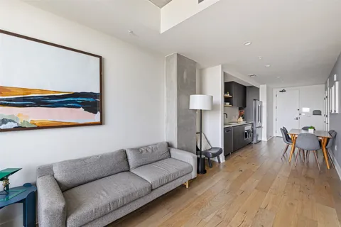 a living room with furniture and kitchen view
