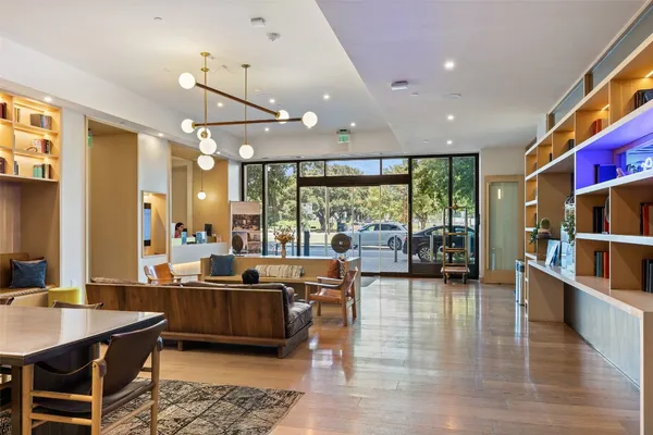 a living room with lots of furniture and a large window