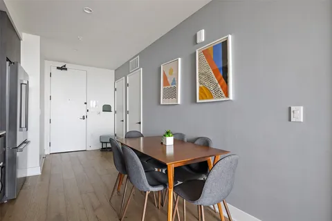 a view of a dining room with furniture and wooden floor