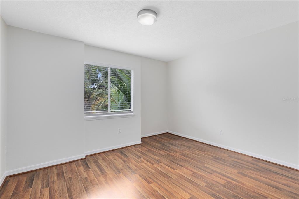 1938 South Conway Road, Unit 5 Orlando, FL 32812 - Photo 12 of 21 wooden floor in an empty room with a window