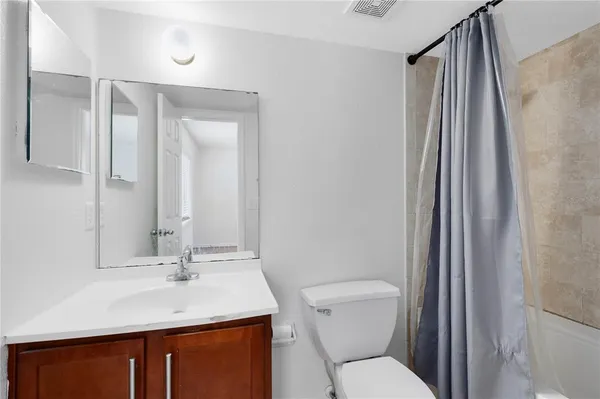 a bathroom with a toilet sink shower and mirror