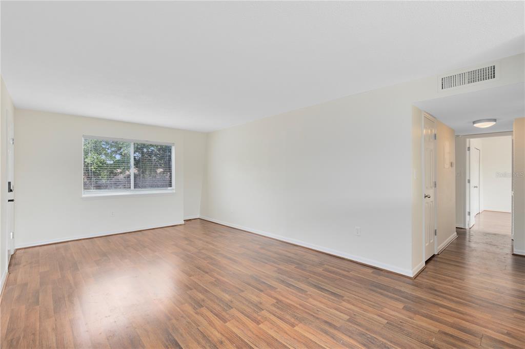 1938 South Conway Road, Unit 5 Orlando, FL 32812 - Photo 14 of 21 an empty room with wooden floor and windows