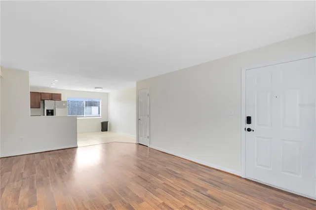 a view of a room with wooden floor and window