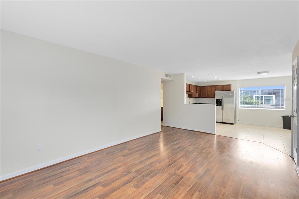 1938 South Conway Road, Unit 5 Orlando, FL 32812 - Photo 4 of 21 a view of a kitchen with wooden floor and electronic appliances