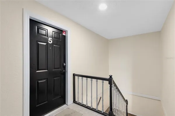 a view of a hallway with wooden floor and entryway