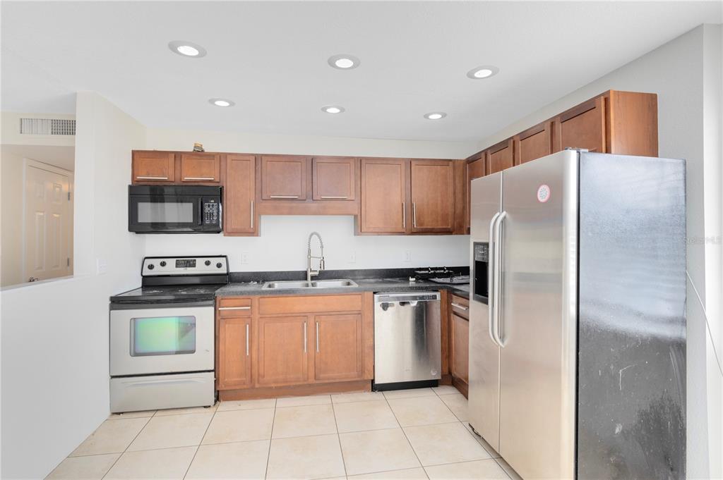 1938 South Conway Road, Unit 5 Orlando, FL 32812 - Photo 7 of 21 a kitchen with stainless steel appliances granite countertop a refrigerator stove and sink
