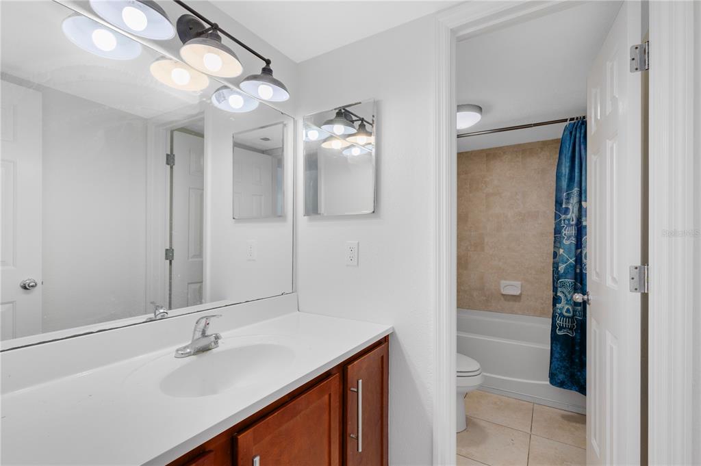 1938 South Conway Road, Unit 5 Orlando, FL 32812 - Photo 9 of 21 a bathroom with a sink vanity granite tub and shower