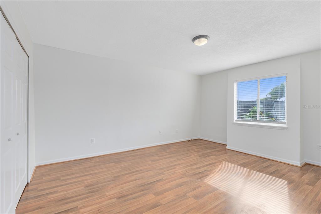 1938 South Conway Road, Unit 5 Orlando, FL 32812 - Photo 10 of 21 a view of an empty room with wooden floor and a window