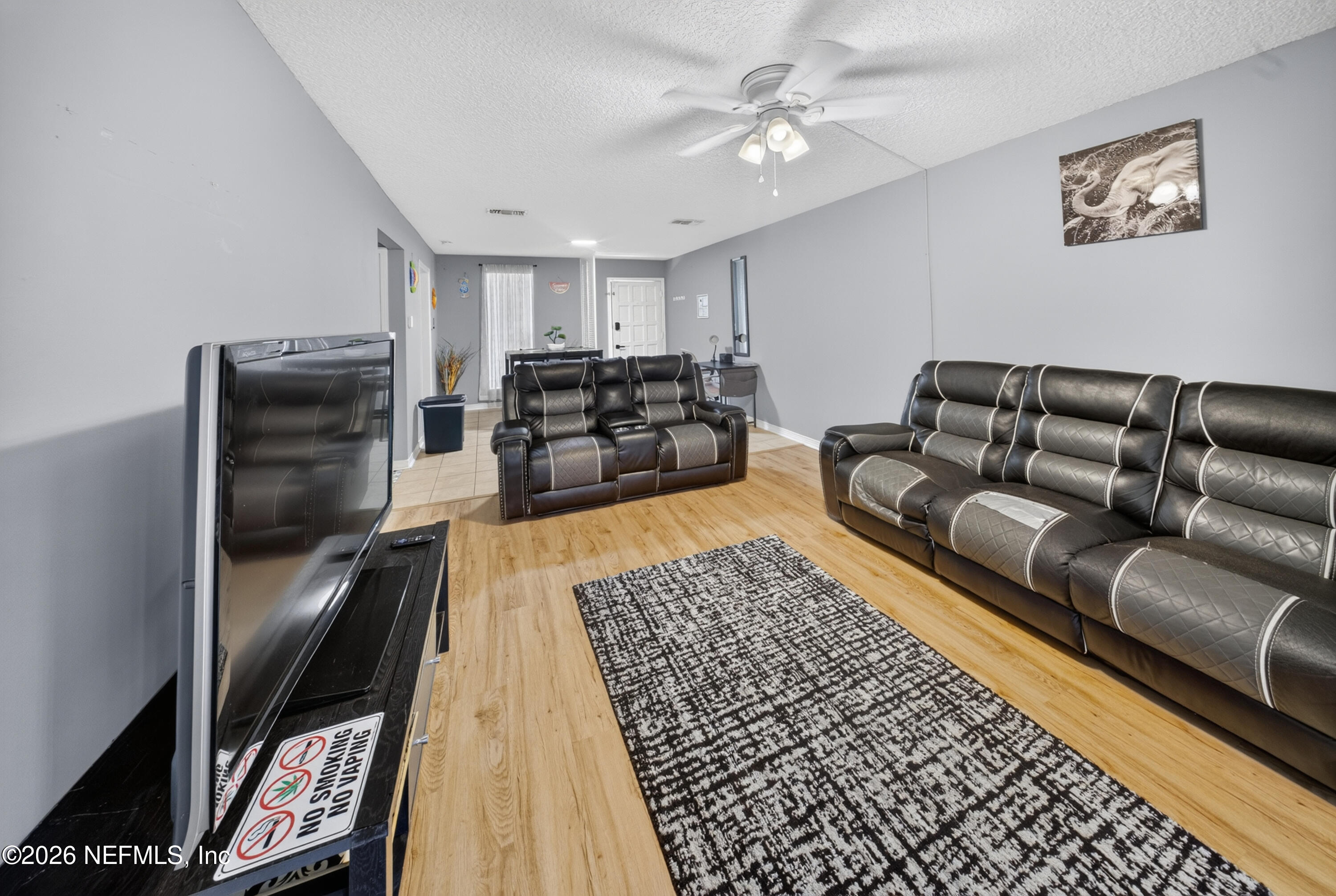 7346 El Barco Road, Unit 4 Jacksonville, FL 32216 - Photo 2 of 19 a living room with furniture and a rug