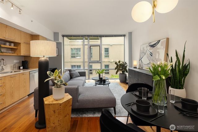 a living room with furniture potted plant a fireplace and a window