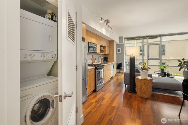 a view of living room with furniture and wooden floor