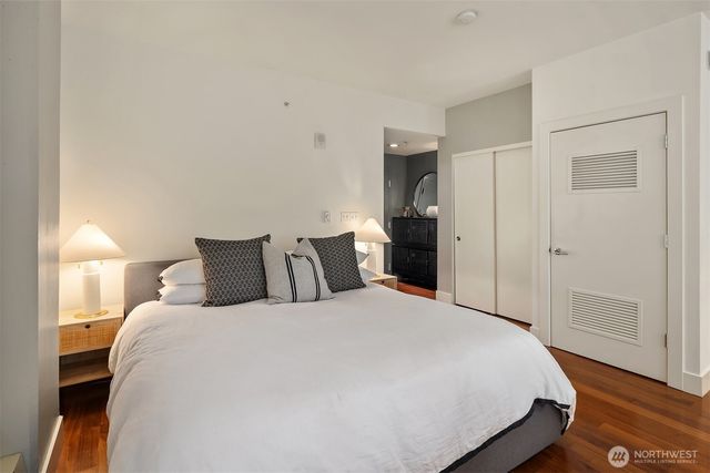 a bedroom with a bed and wooden floor