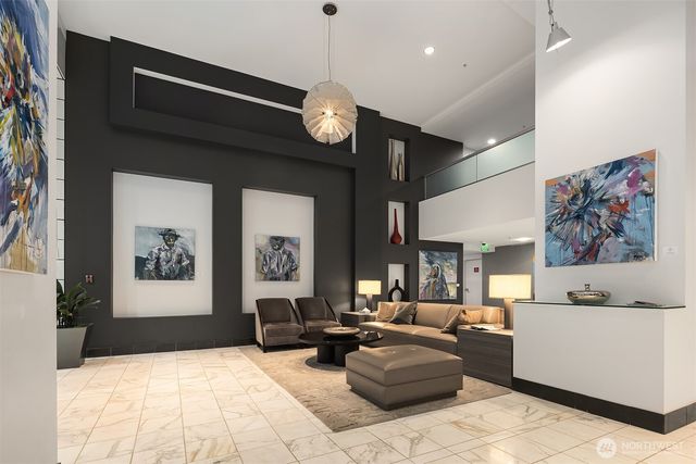 a living room with furniture and a chandelier