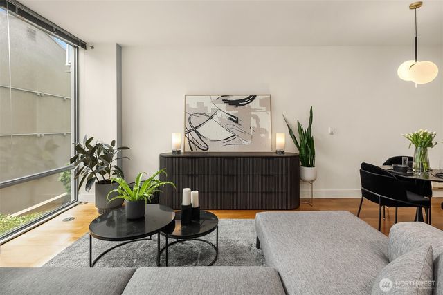 a living room with furniture and a potted plant