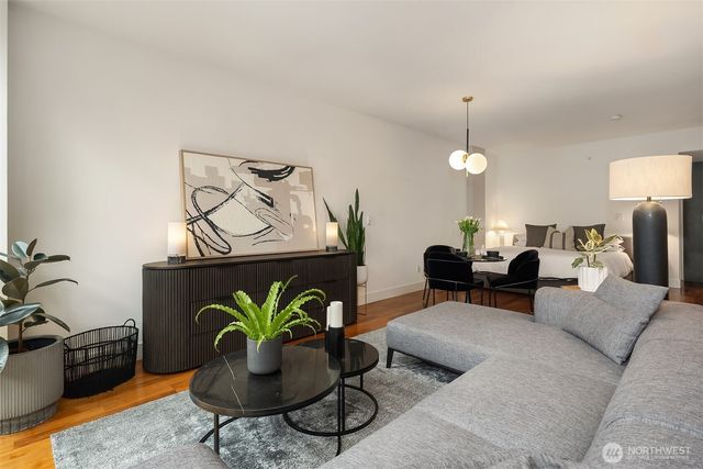 a living room with furniture and wooden floor