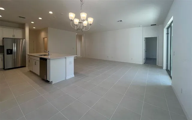 a kitchen with stainless steel appliances a refrigerator and a counter top space
