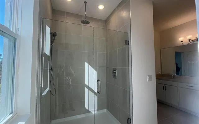 a bathroom with a shower and a glass door