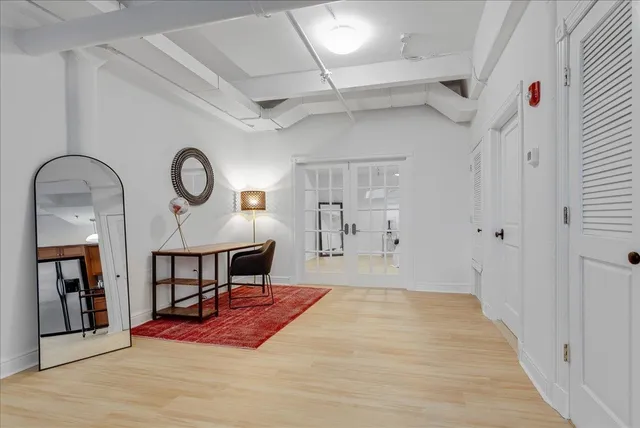 a view of a hallway to a livingroom and a dinning area with furniture
