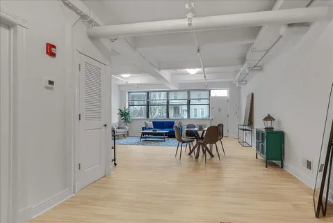 a view of a hallway to a livingroom and a dinning area with furniture