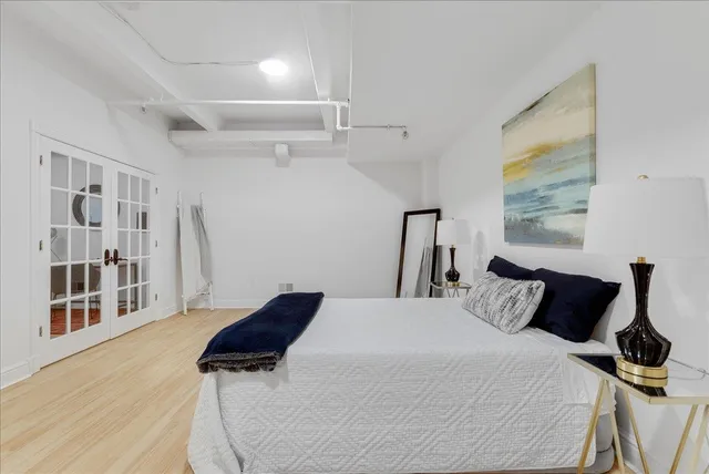 a bedroom with a bed and a window