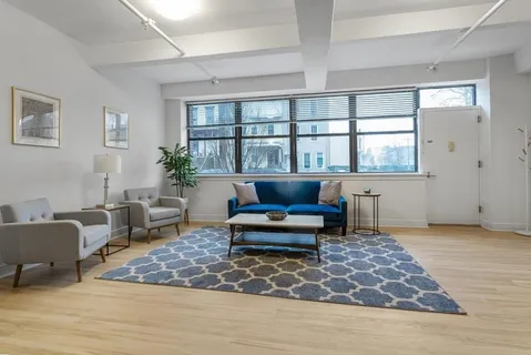 a living room with furniture and a rug