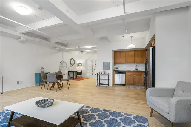 a living room with furniture and wooden floor
