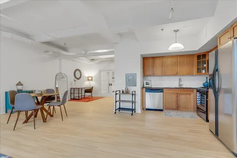 a kitchen with stainless steel appliances granite countertop a sink stove and refrigerator