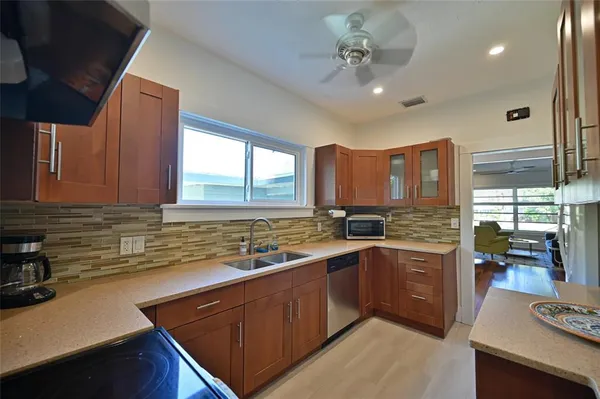 a kitchen with a sink stove and cabinets