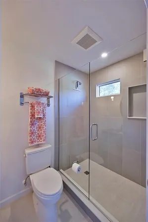 a bathroom with a toilet a sink and shower