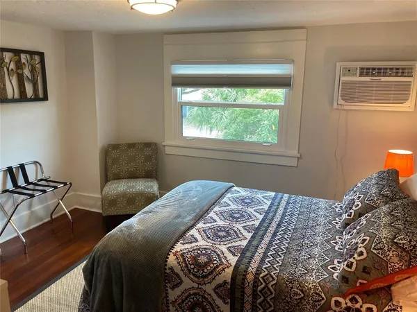 a bedroom with a bed and a window