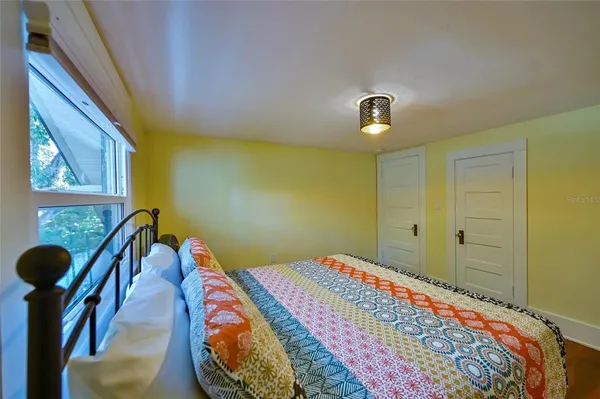 a bedroom with a bed and a window