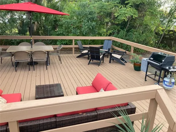 a view of backyard with swimming pool and outdoor seating