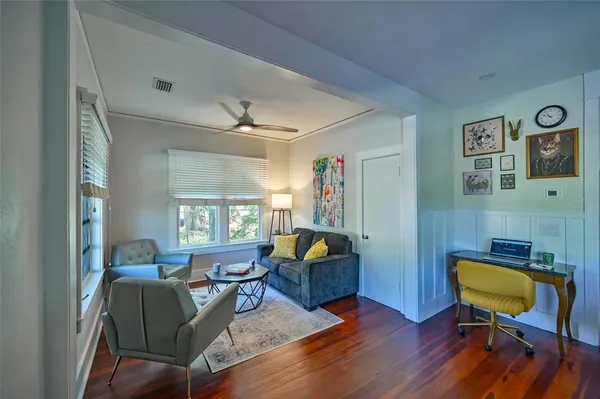 a living room with furniture and wooden floor