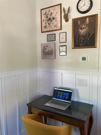 a living room with furniture and wall paintings