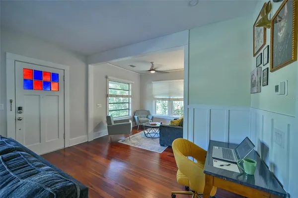 a living room with furniture and wooden floor