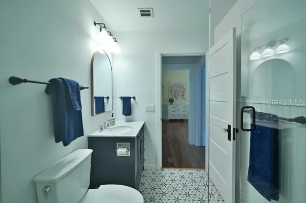 a bathroom with a sink toilet and shower