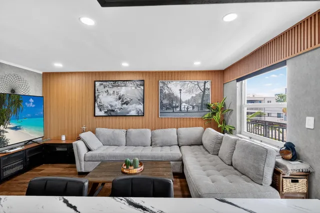 a living room with furniture and a large window