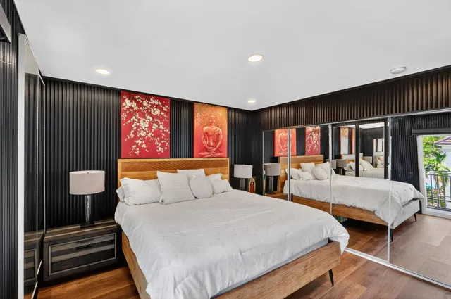 a bedroom with two beds and a flat screen tv