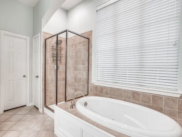 a bathroom with a bathtub and shower