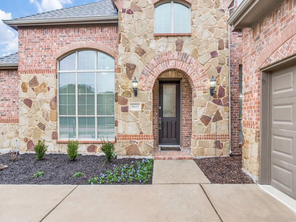9609 Sam Bass Trail Fort Worth, TX 76244 - Photo 2 of 25 a front view of a house with a garden