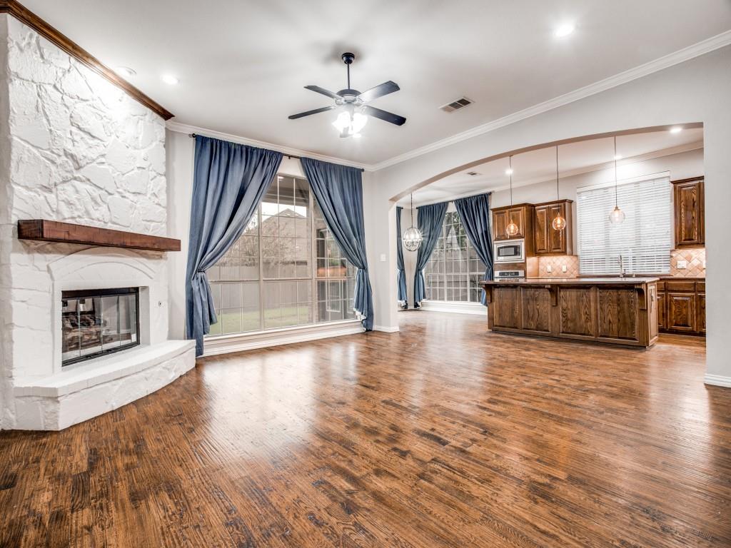 9609 Sam Bass Trail Fort Worth, TX 76244 - Photo 10 of 25 an empty room with wooden floor fireplace and windows