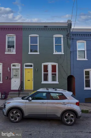 a front view of a house with parking space