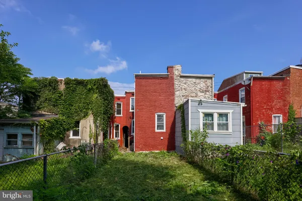 a view of a garden with large trees